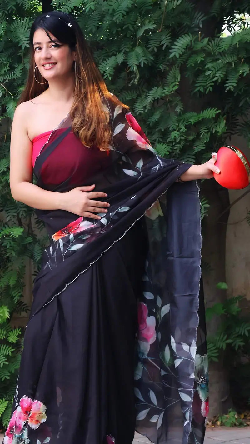 Woman hwearing a floral organza saree in an outdoor setting