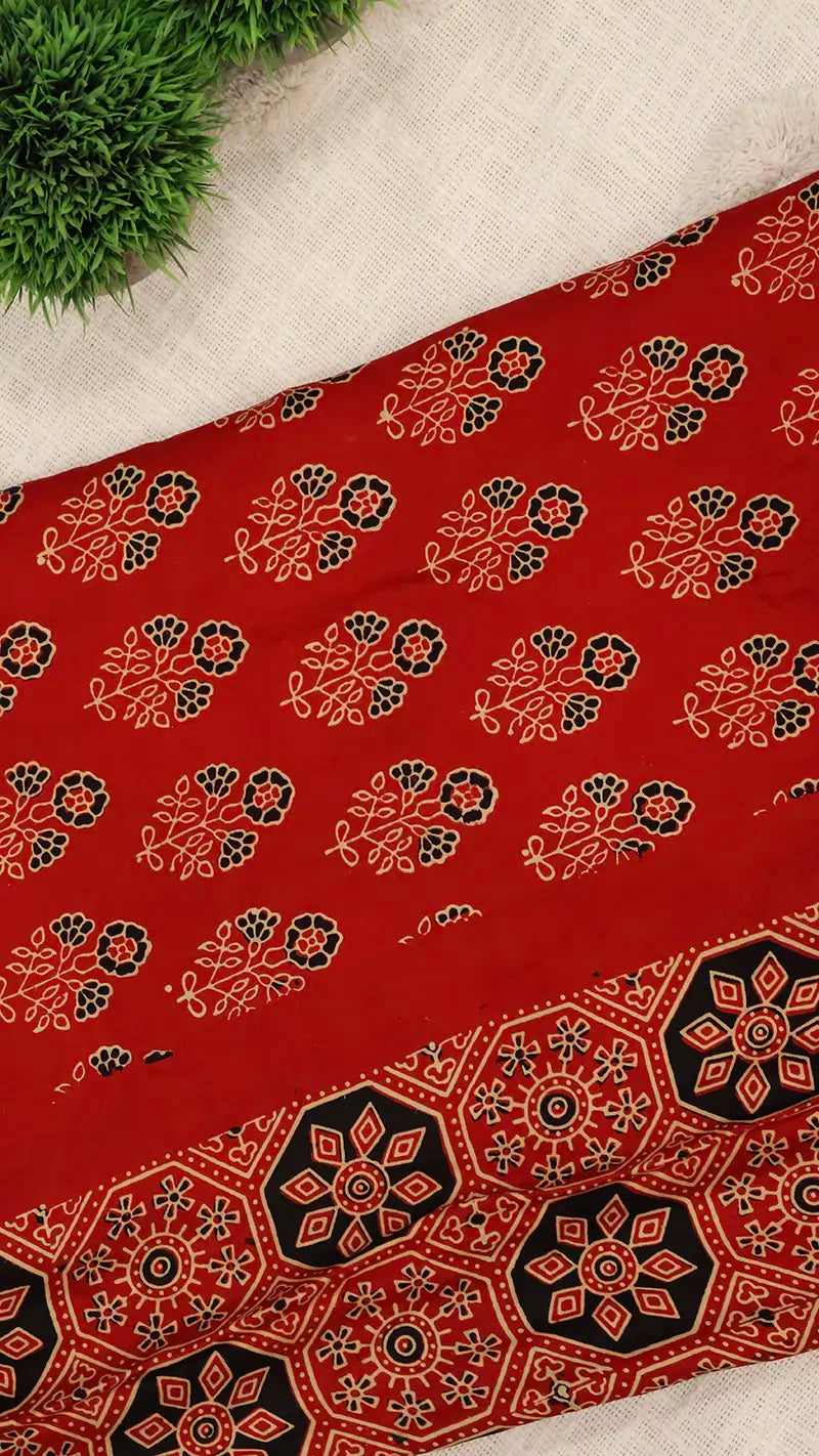 Red blouse piece with ajrakh print on a light background