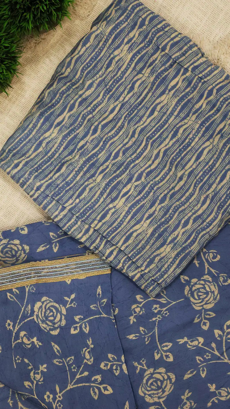 Blue blouse piece with floral patterns on a beige surface