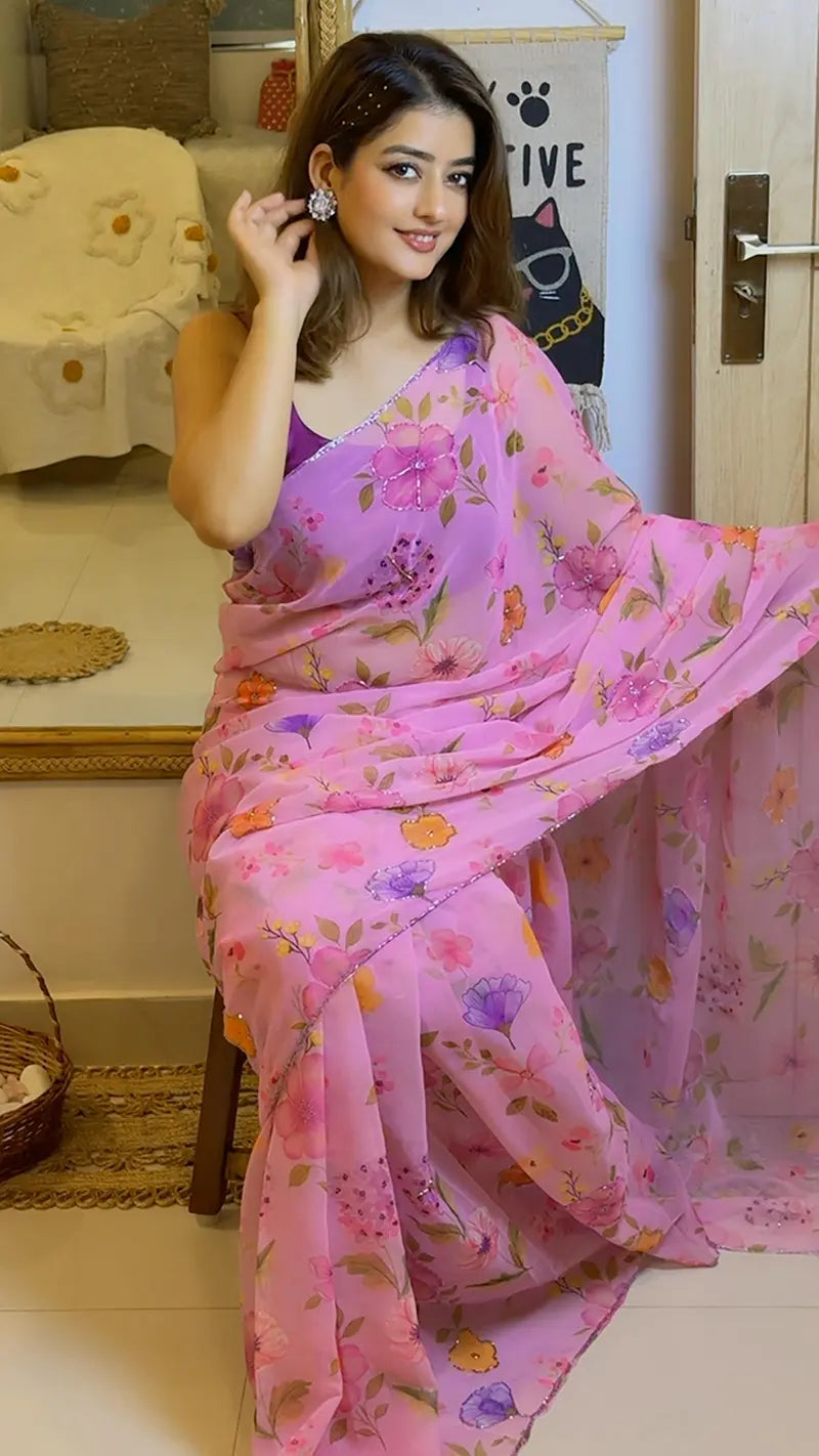 Woman wearing a pink floral georgette saree in an indoor setting