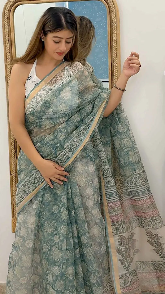 Woman wearing mint green colored kota doriya saree