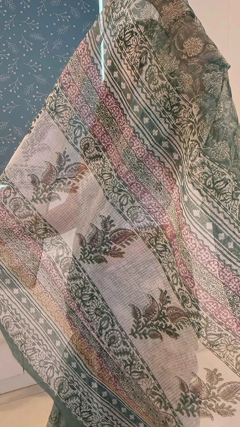 Close-up of a patterned fabric with floral designs on a textured surface.