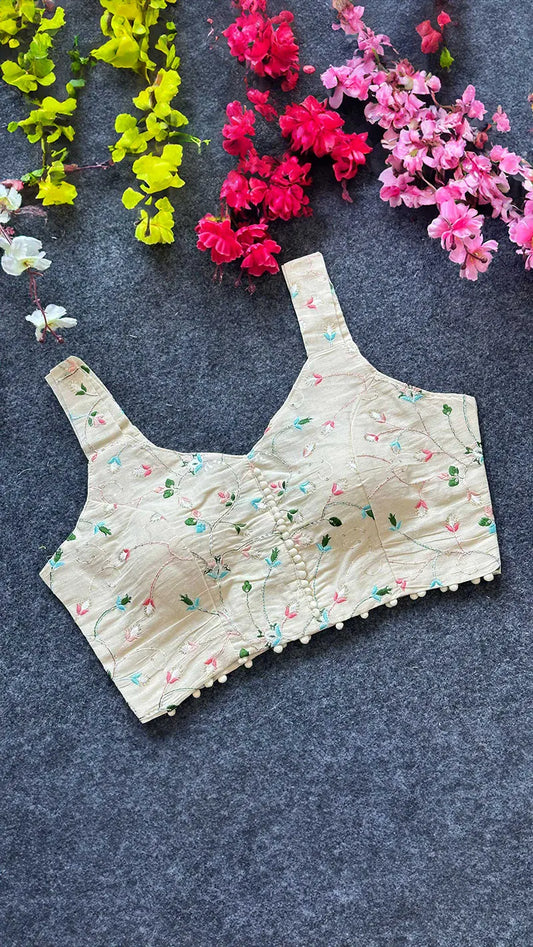 Floral-patterned blouse on a dark surface with flowers around