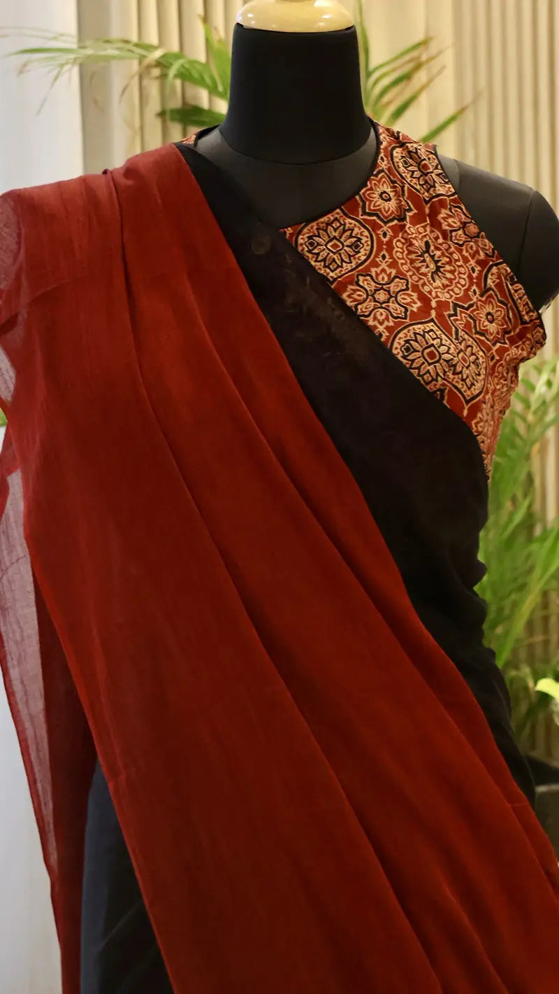 Mannequin wearing a black and red mul cotton saree