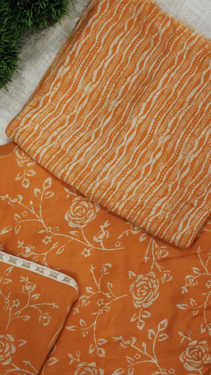 Orange blouse fabric with floral patterns on a textured surface
