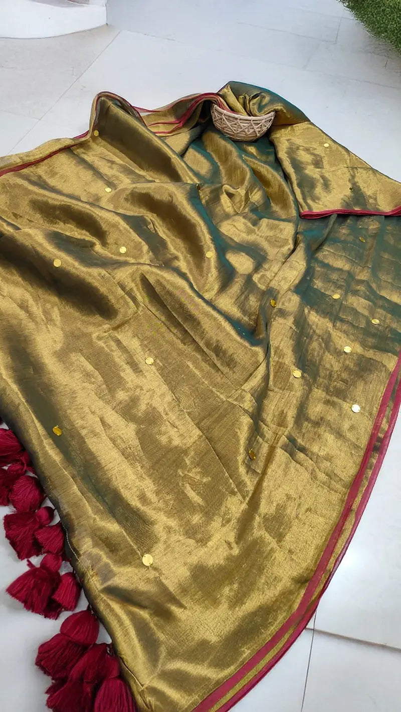 Museli Gold Demure Elegant Tissue Saree with red trim and tassels on a white background